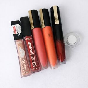 L’Oréal lip bundle 💄 glosses + liquid lipsticks in peach, pink, and red tones.